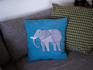 Elephant pillow on blue linen