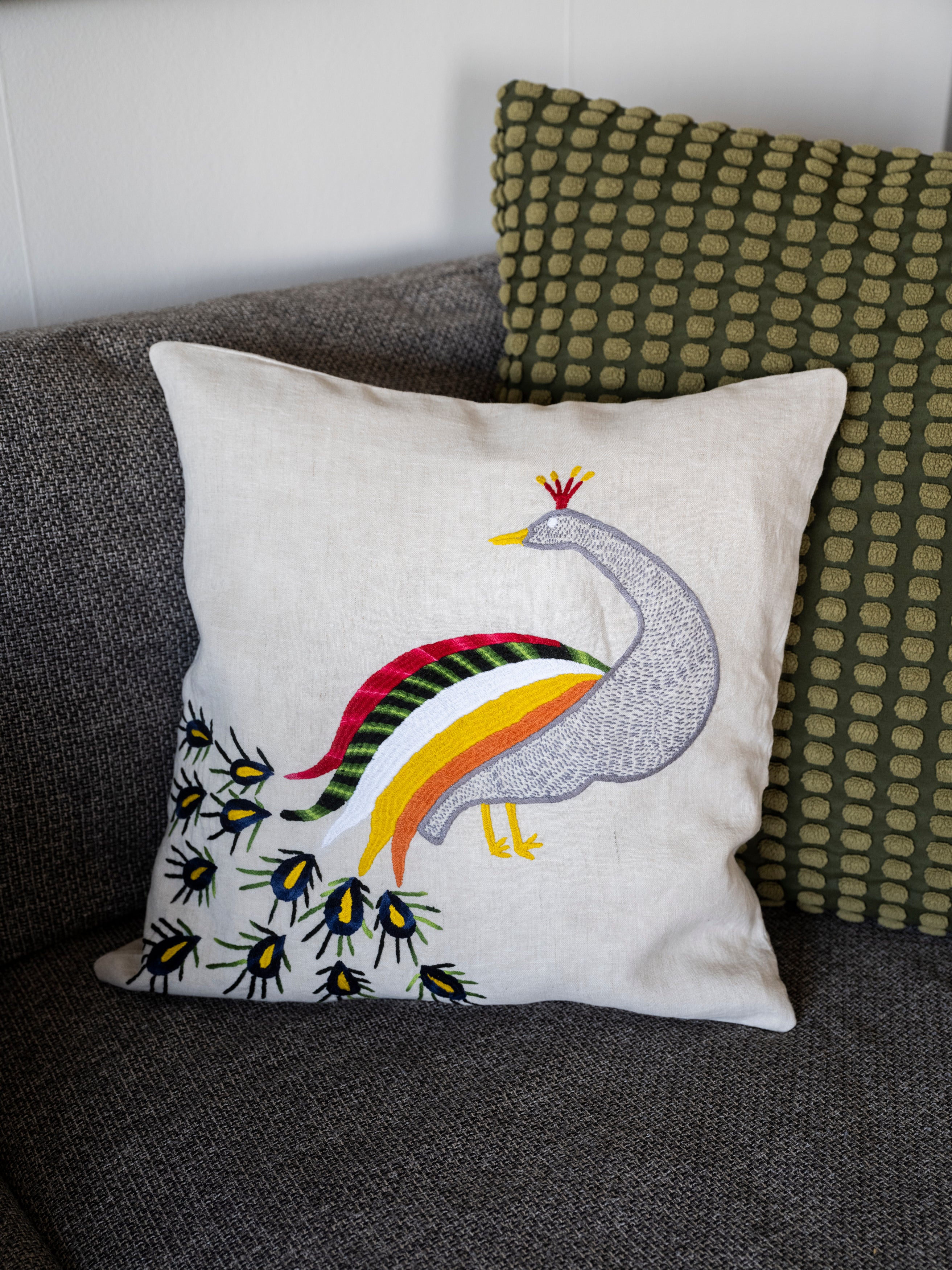 Peacock pillow on natural linen