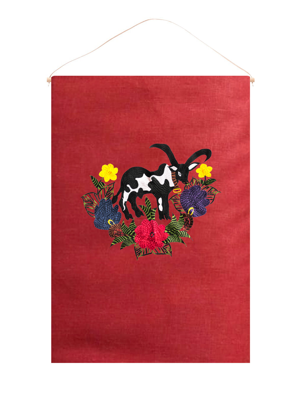 Cow wall hanging on red linen