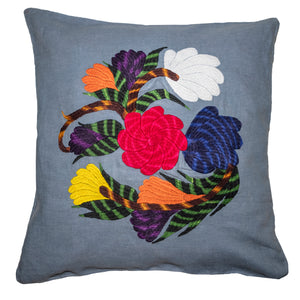 Flower pillow on blue linen