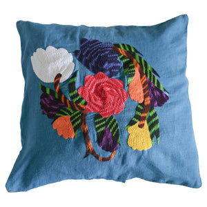 Flower pillow on blue linen