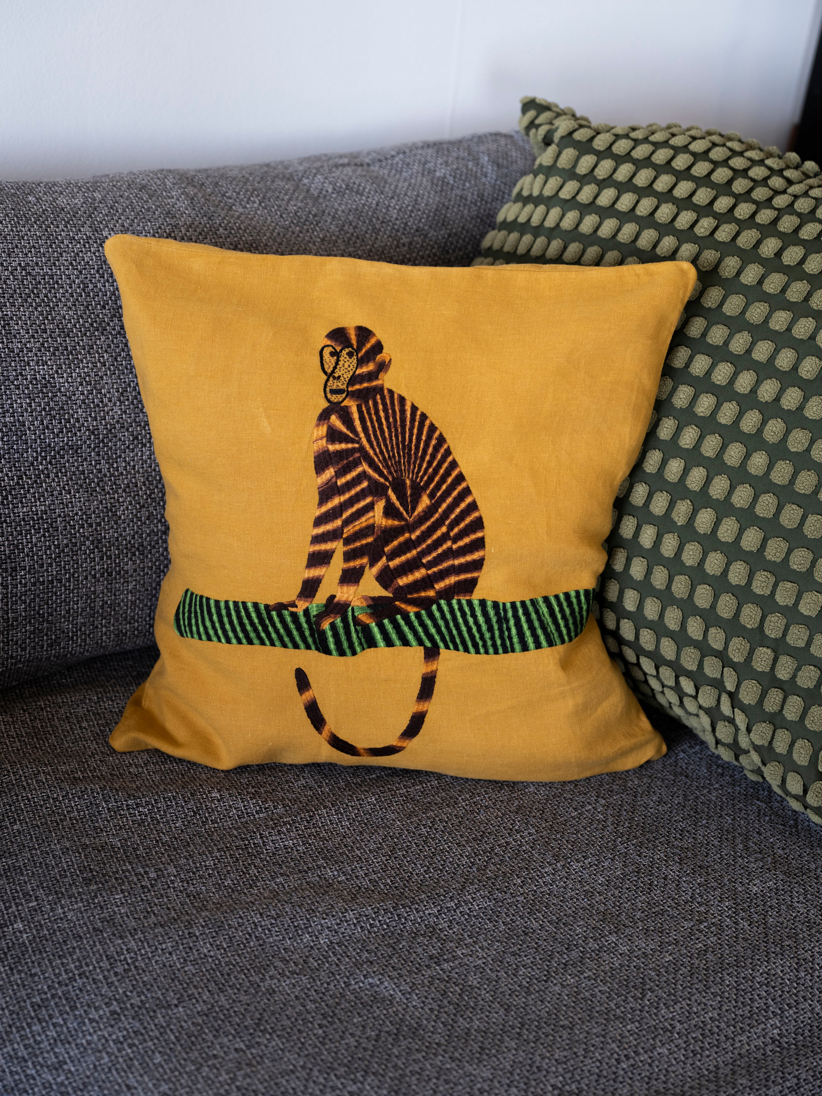 Monkey pillow on yellow linen