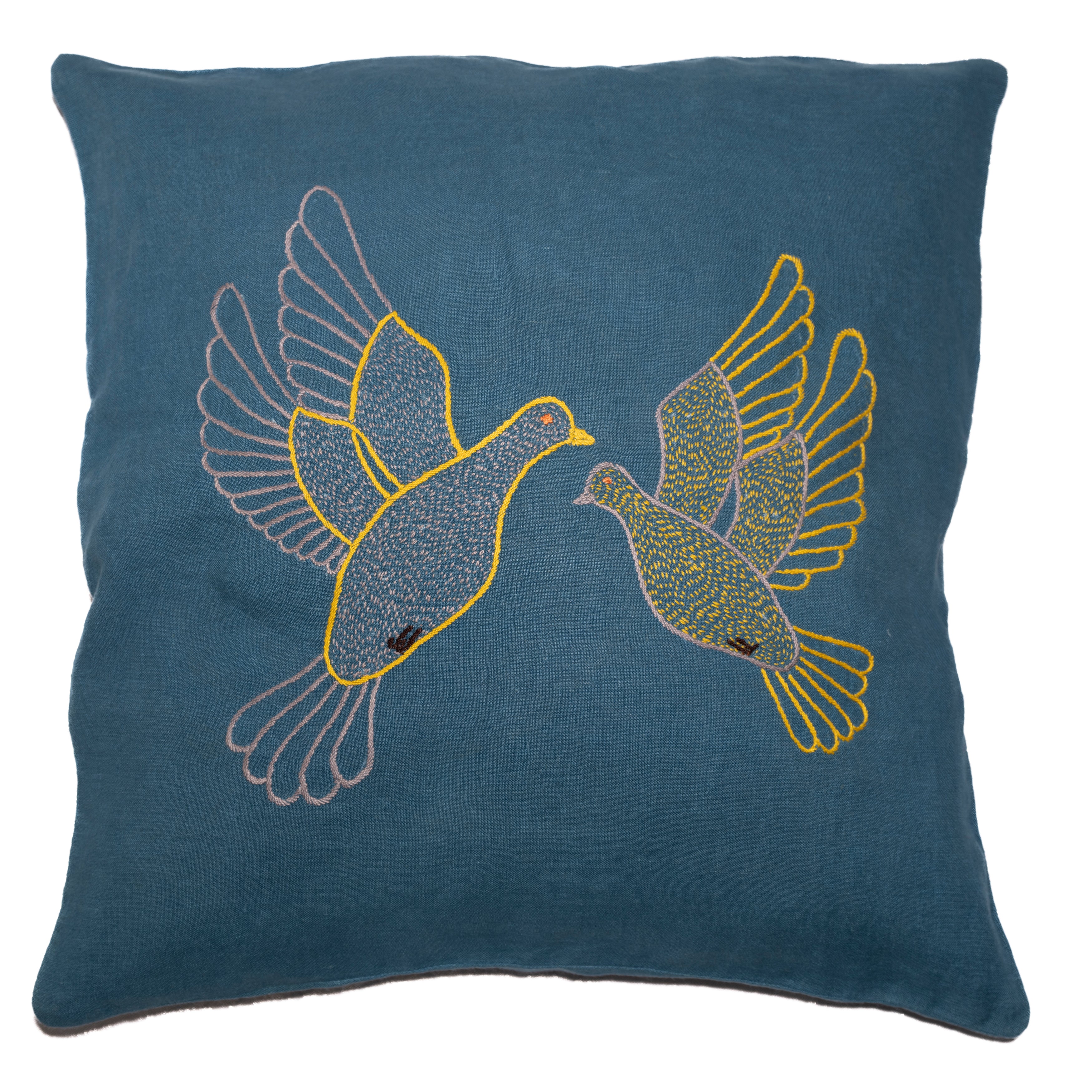 Flying dove pillow on blue linen