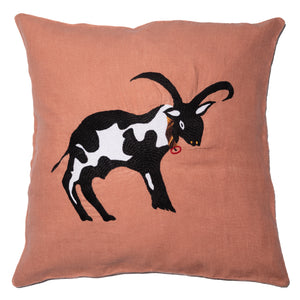Cow pillow on pink linen