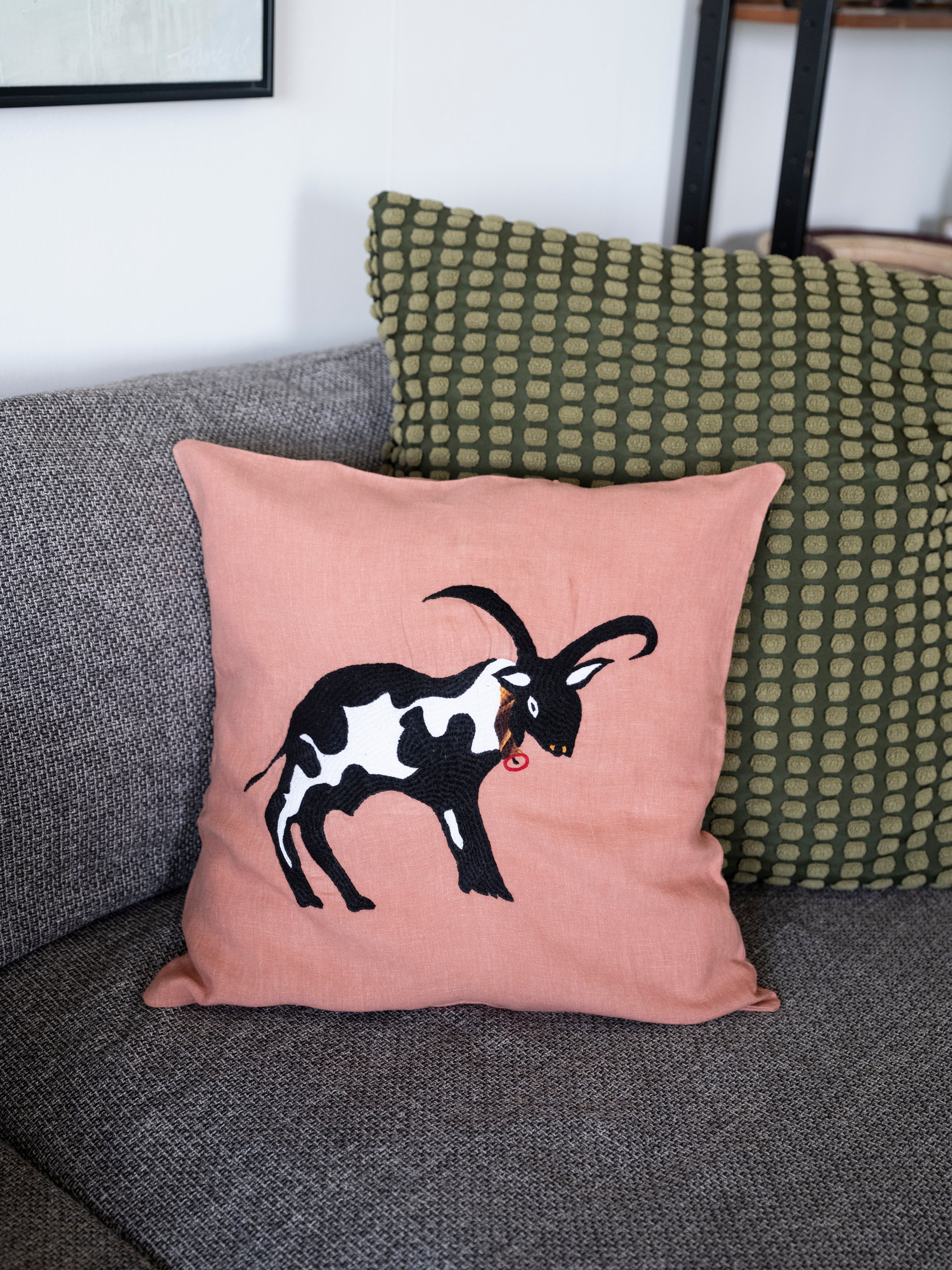 Cow pillow on pink linen
