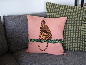 Monkey pillow on pink linen