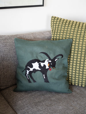 Cow pillow on emerald linen