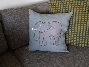 Elephant pillow on light blue linen