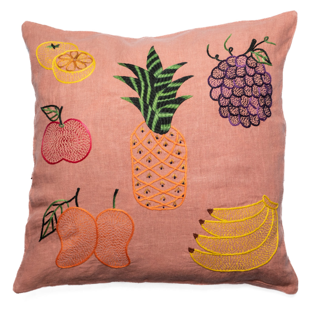 Decorative pillow with embroidered fruit designs on a pink background