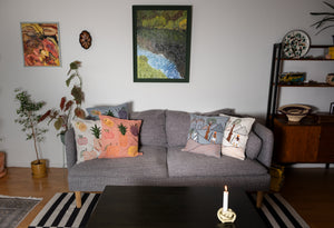 Living room with a gray sofa, decorative pillows, and a coffee table.