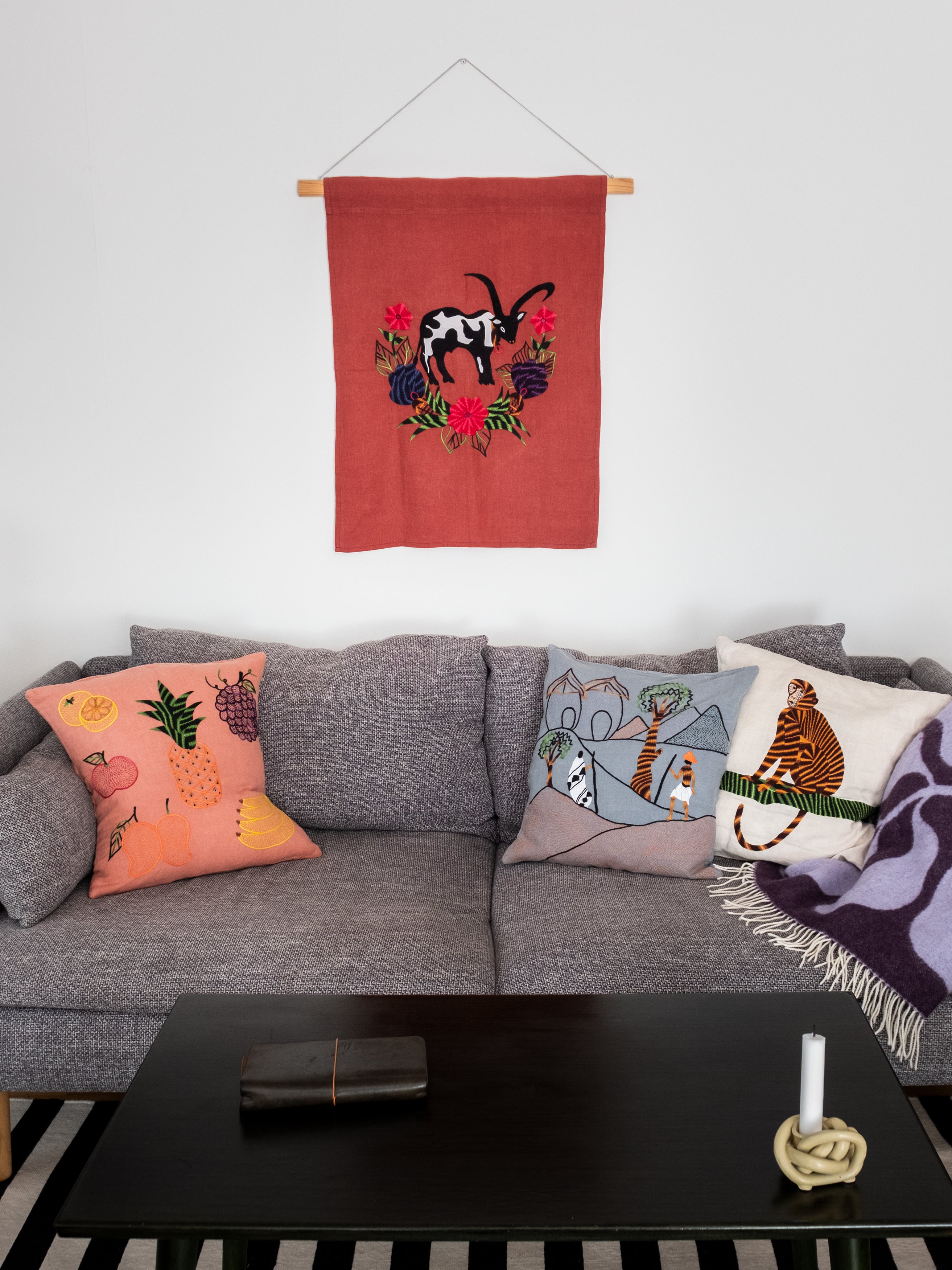 Cow wall hanging on red linen