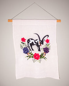 Cow wall hanging on natural linen