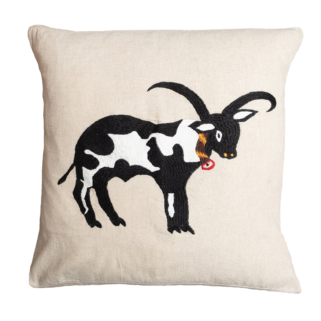 Cow pillow on natural linen